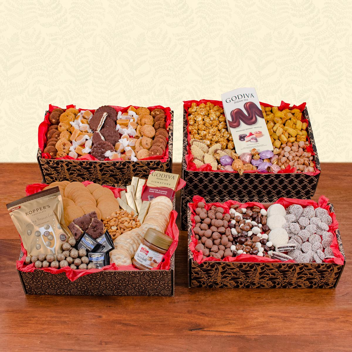 Gourmet gift baskets with assorted chocolates, cookies, and nuts on a table.